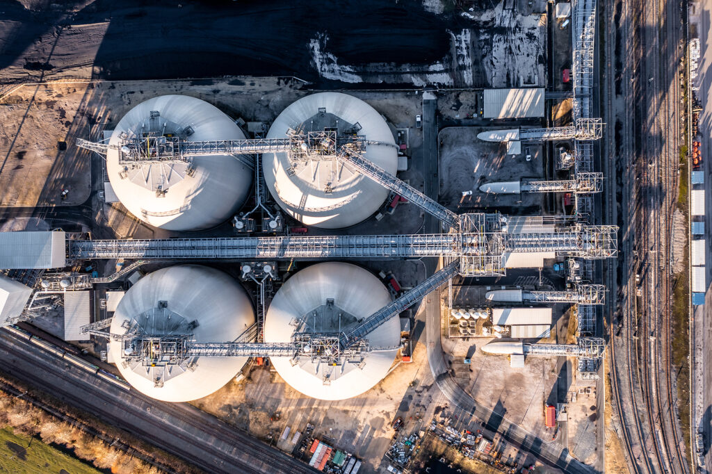 Aerial view directly above the large biofuel storage tanks holding huge amounts of biomass for renewable and sustainable energy